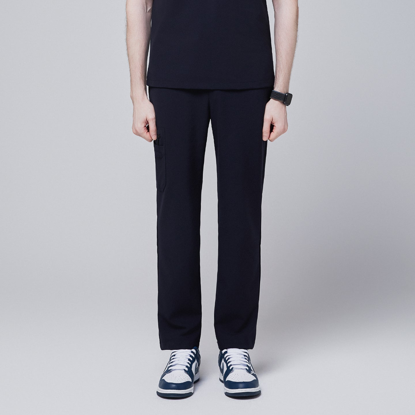 Image of Male model wearing midnight navy relaxed-fit scrub pants with side pocket, standing in a neutral pose, showing the front view of the pants, against a plain background,Midnigh Navy